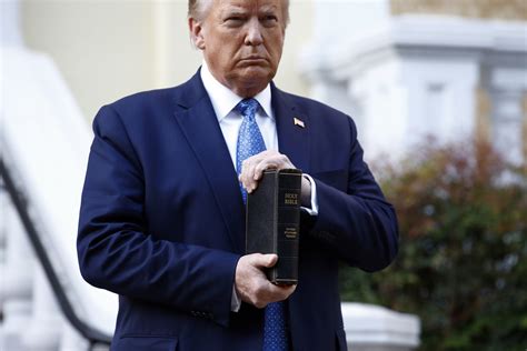 trump holds up bible